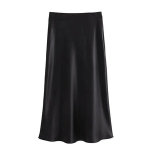 Jupe Le Reflet Serein noire en polyester satiné, coupe midi taille haute